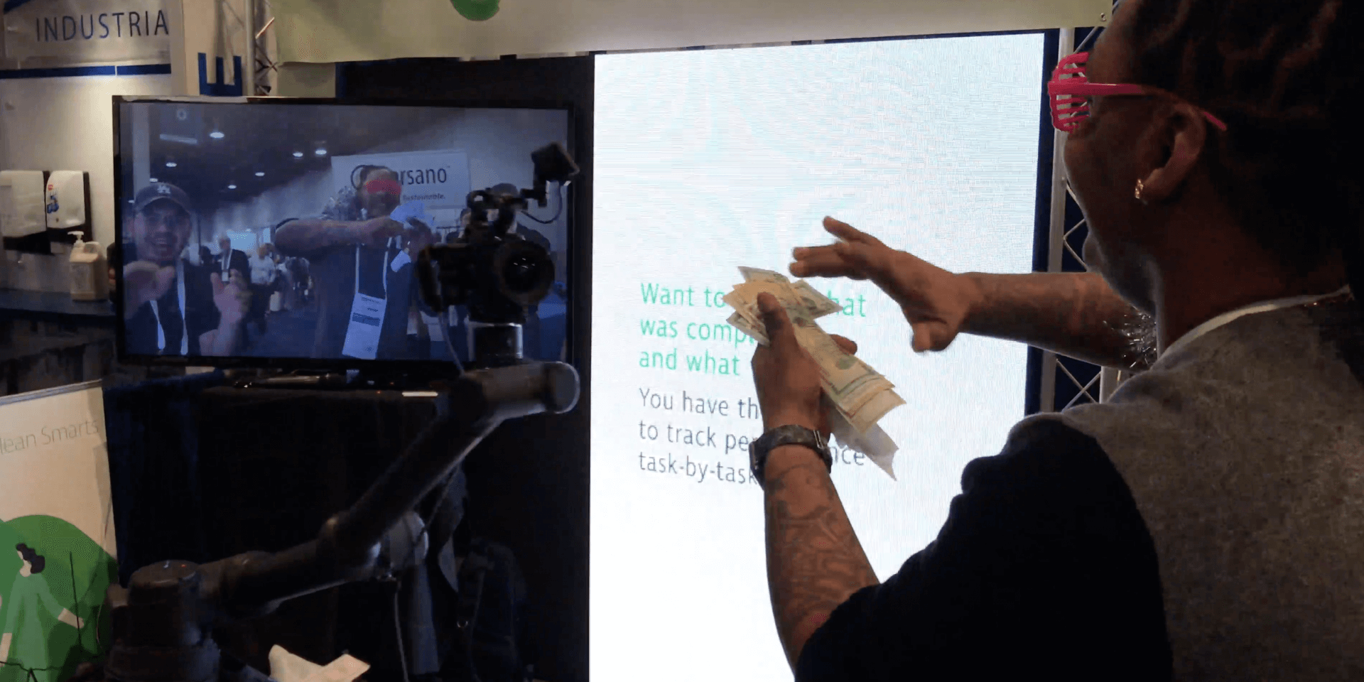 Trade show guest interacting with a robotic camera activation