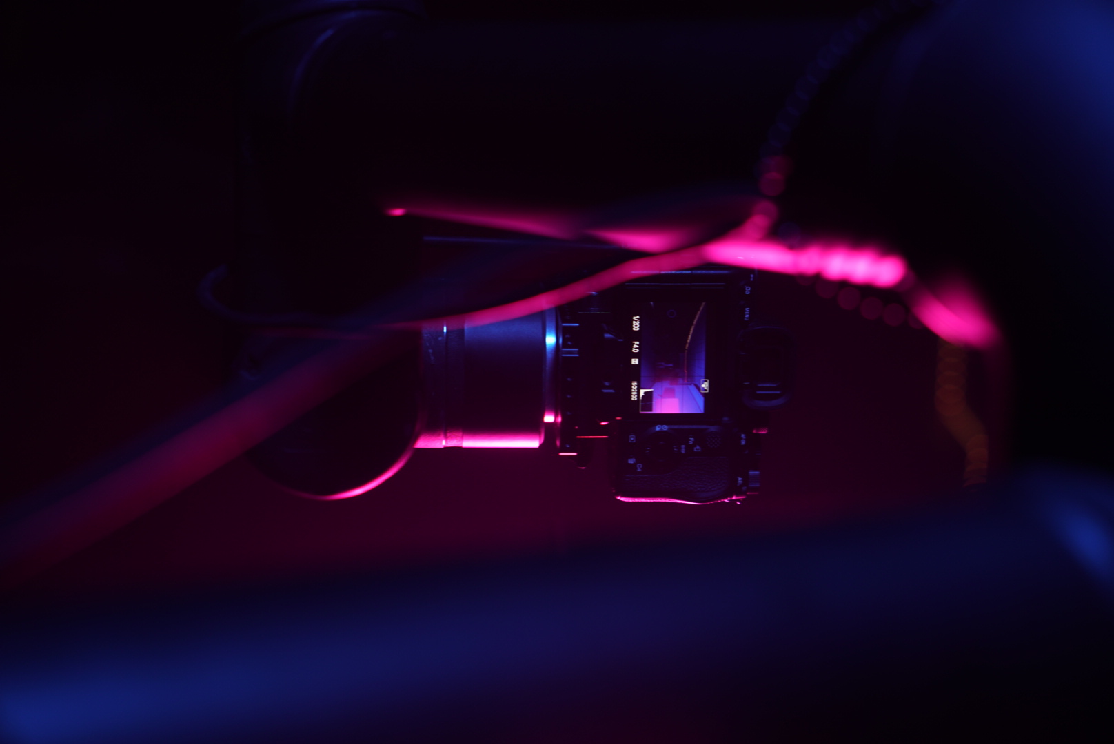 Robotic camera illuminated by magenta and blue event lighting